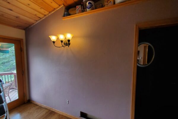 Refreshed interior wall with warm sconce lighting